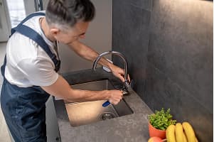 Plumber fixing sink